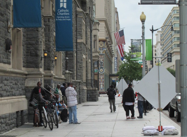 Homeless people in front of the Martin Luther King Jr. Library in Washington DC, waiting for shuttles that will take them to food shelters. Credit: Ramy Srour/IPS